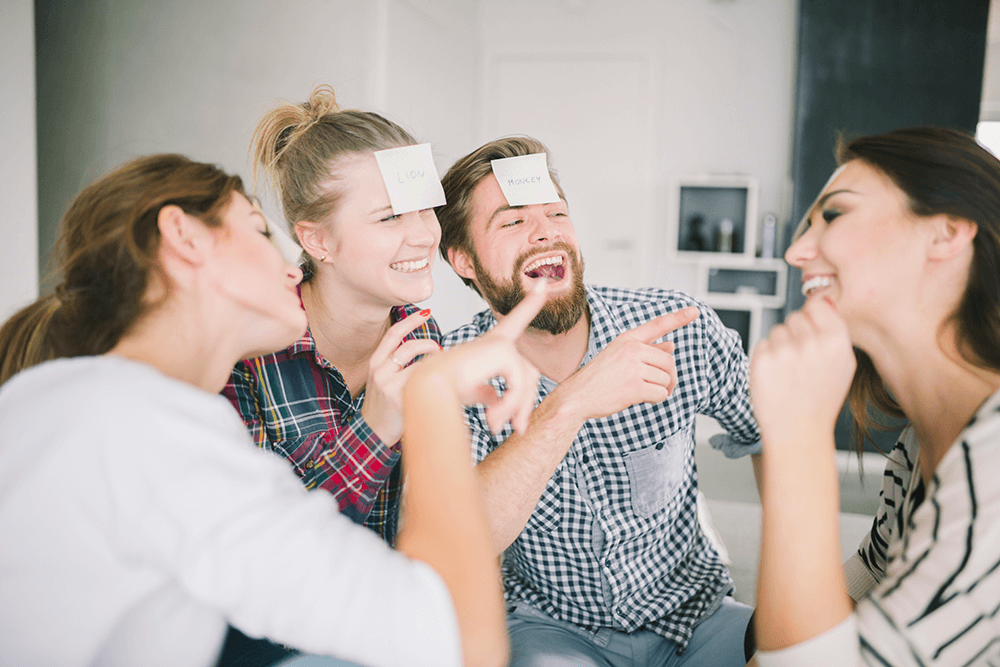 Friends laughing while playing a game